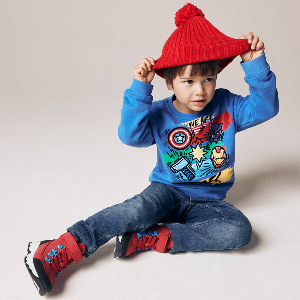 A child wearing brightly-coloured casualwear. Kidswear